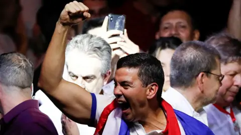 Santiago Peña (centre) celebrates at the Colorado Party headquarters in Asunción, Paraguay. Photo: 30 April 2023