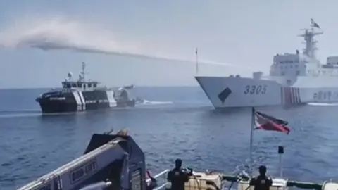 Ship firing water in South China Sea