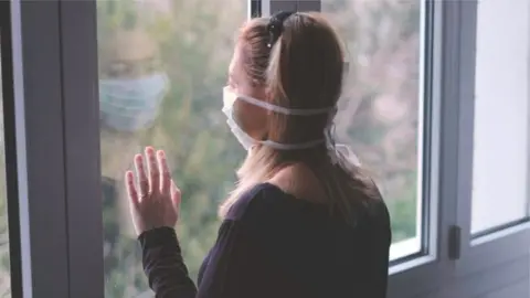 Getty Images A woman wearing a face mask