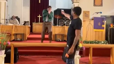 Gunman aims at pastor