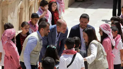 Getty Images Prince William met a group of Syrian and Jordanian children at the archaeological site