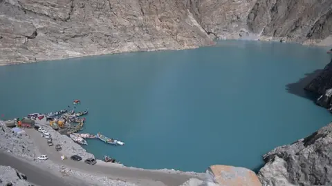 Getty Images Pakistani residents board boats used to cross Attabad Lake