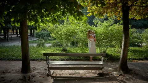 Getty Images Image shows mother and baby in park
