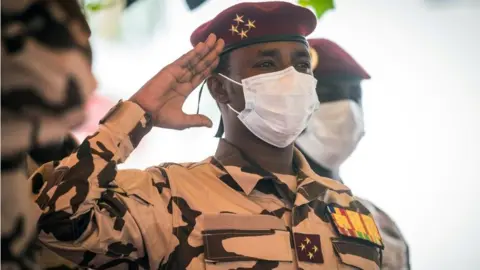 AFP Mahamat Idriss Deby pays his respects near the coffin during the state funeral for his father Chadian president Idriss Deby in N'Djamena, on April 23, 2021