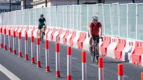 PA Media Cyclists near roadworks on London Bridge