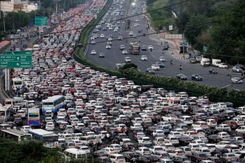 Vinay Gupta / AFP Vehicles are seen stuck in bumper to bumper traffic on the Delhi-Jaipur expressway in Gurgaon