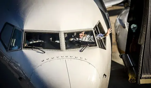 Getty Images A pilot waves as a Ryanair plane arrives at Schipol Airport in Amsterdam, The Netherlands, on October 27, 2015