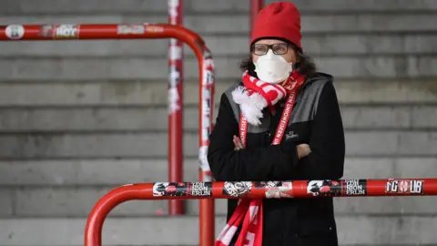 Reuters FC Union Berlin fan wearing a protective face mask in the stand as coronavirus (Covid-19) restrictions
