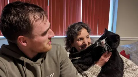 RSPCA Rescuer Seth Masters pictured with Princess and her owner Sonia Wilkinson