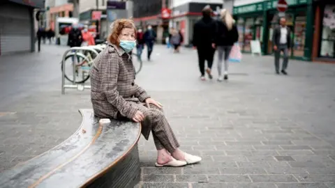 Getty Images Woman wearing face mask in Liverpool