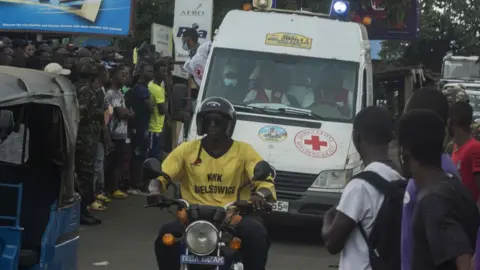 Getty Images People at the fire site in Sierra Leone, 6 November