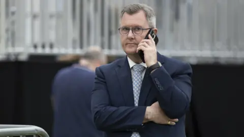 PA Sir Jeffrey Donaldson talks on his mobile phone