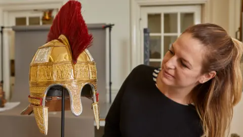 Birmingham Museum Lizzie Miller with one of the reconstructed helmets