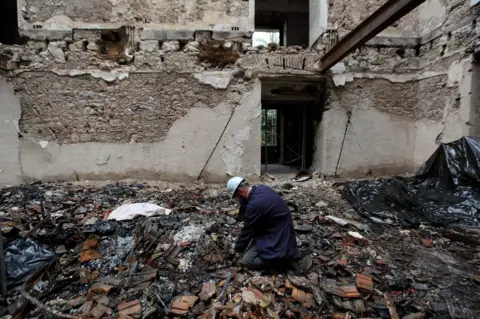 Douglas Engle Archeologist Pedro Luiz von Seehausen searches through the rubble for Egyptian steles at the National Museum in Rio de Janeiro