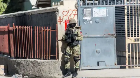 AFP A policeman guards the perimeter of the Croix-des-Bouquets prison