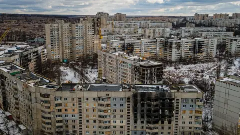 Getty Images/IHOR TKACHOV An aerial view of residential buildings damaged by shelling in Kharkiv on 20 February, 2023