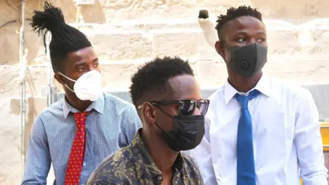 BBC/Joanna Demarco Abdalla, Abdul and Lamin outside court in Malta