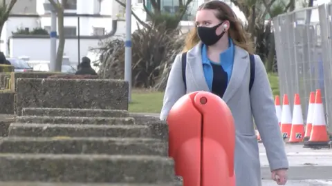 BBC Woman walking along Douglas promenade