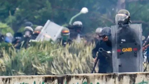 AFP A member of the National Guard holds a gun during clashes with opposition activists demonstrating against the government of President Nicolas Maduro along the Francisco Fajardo highway in Caracas on June 19, 2017.