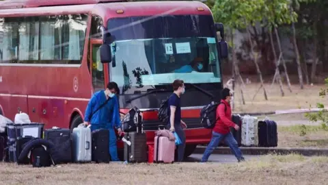 ANH PHONG New arrivals in Vietnam arrive at a quarantine centre