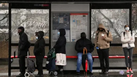 Reuters People at bus stop