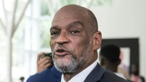 Getty Images Ariel Henry attends a ceremony in honour of late Haitian President Jovenel Moise at the National Pantheon Museum in Port-au-Prince, Haiti, on July 20, 2021.