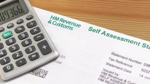 Getty Images End of year working out inland revenue tax self assessment form with calculator