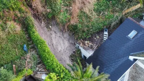 Island Echo landslip behind a roof