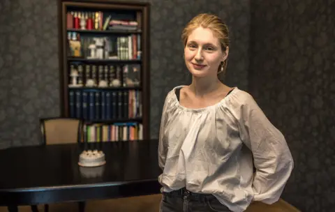 BBC Sonia, the vegan baker who runs Run Rabbit Run, photographed in front of a bookcase