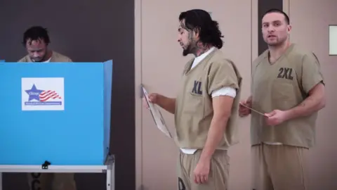 Getty Images Men cast their ballots at Cook County Jail during the Illinois primary election