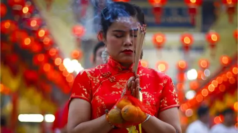 EPA Worshippers burn incense in prayer at a temple to celebrate the Lunar New Year, or Spring Festival, in Chinatown in Bangkok, Thailand