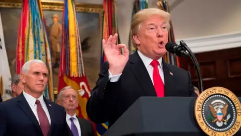 Getty Images Mr Trump makes remarks before signing a defense budget authorisation on Tuesday