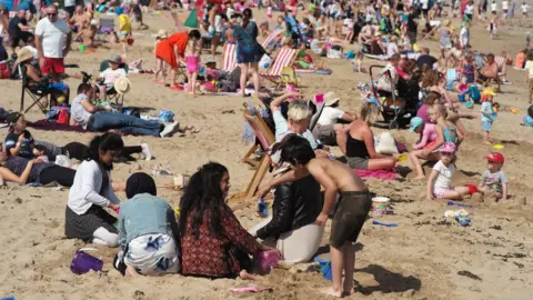 Christopher Furlong/Getty Holidaymakers basked in the sunshine in Llandudno during a heatwave in August