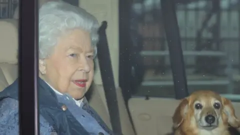 PA Media The Queen with one of her corgis, leaving Buckingham Palace