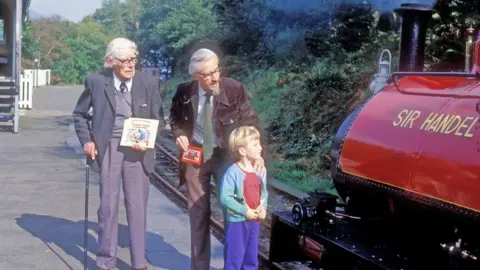 Talyllyn Railway The Rev. W Awdry, his son Christopher and grandson Richard with Loco No. 3 'Sir Handel' in September 1985 at Talyllyn Railway