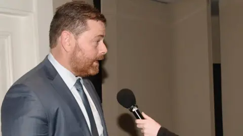 Safer Blanchardstown PSNI Inspector Francey speaking into a microphone