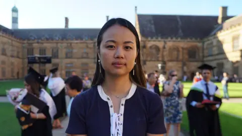 BBC Liliana Tai in front of university graduates at the University of Sydney