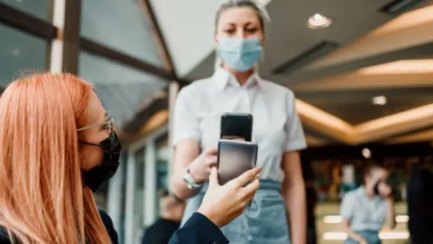 Getty Images vaccine certificate in pub