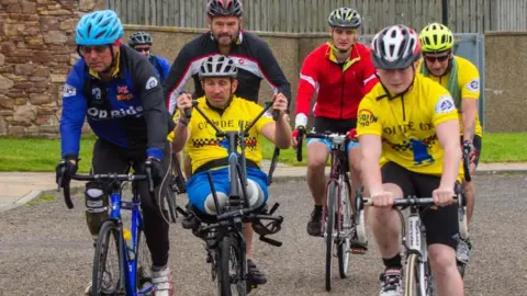 Arlene Chart Ben Parkinson riding an adapted bike