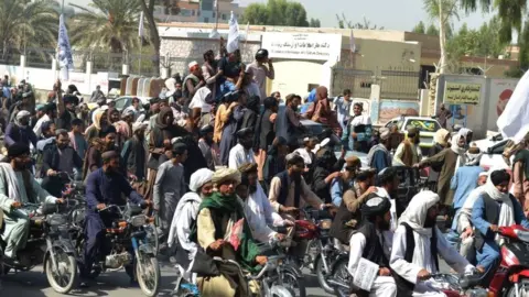 AFP via Getty Images Taliban supporters celebrate along a street in Kandahar on August 31, 2021