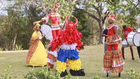 Jody Sallons-Day Performers in colourful dress welcomed the royals on 25 April during their visit to Antigua and Barbuda