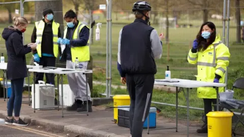 Reuters People take coronavirus tests on Clapham Common in London