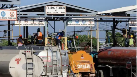Reuters Tanker trucks being filled with fuel at the Varreux terminal in Port-au-Prince, Haiti in November 2021