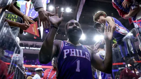 James Harden of the Philadelphia 76ers celebrates with fans after defeating the Boston Celtics in overtime