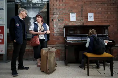 Dave Charnley Malcolm Ingram, Jill Robinson and her daughter Katie Robinson at the Darlington piano