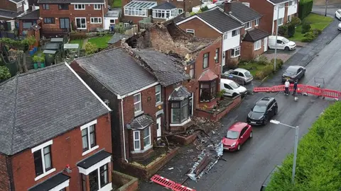 EPA-EFE/REX/Shutterstock Aerial photograph of a house which had its roof ripped off during a localized tornado