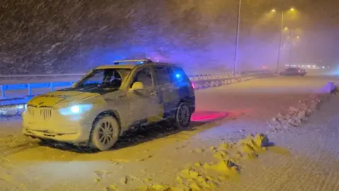 Police vehicle stopped on M62 J22