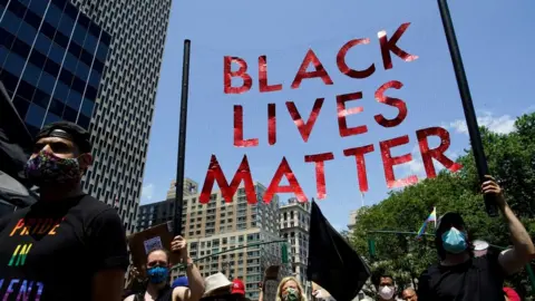 Reuters People hold a sign as they take part in a joint LGBTQ and Black Lives Matter march on the 51st anniversary of the Stonewall riots in New York City, New York, U.S. June 28, 2020.