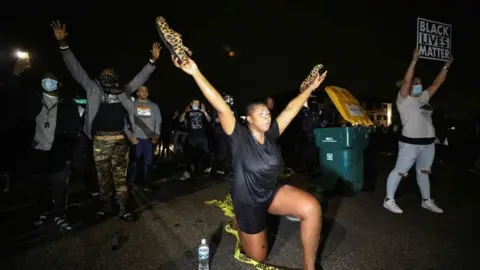 Reuters Protesters outside the police HQ in Brooklyn Center