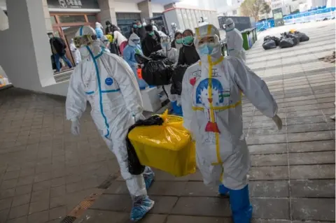 EPA Medical staff clean up the empty hospital after all patients were discharged at Wuchang Fangcang hospital, a temporary hospital set up at Hongshan gymnasium to treat people infected with the coronavirus and Covin-19 disease, in Wuhan, Hubei Province, China, 10 March 2020 (issued 11 March 2020)